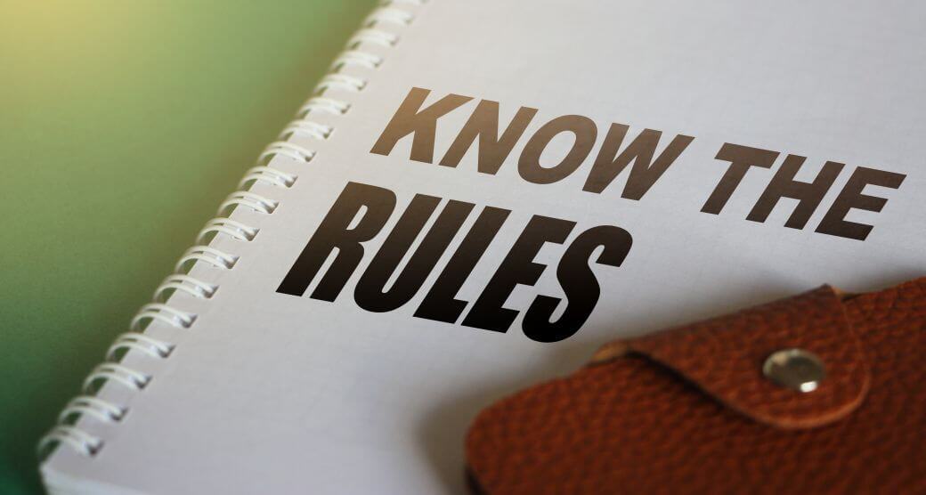 notepad and wallet on desk, notepad with message to 'know the rules' - applicable to navigating aged care rule changes; and other legislation as well, such as superannuation guarantee obligations