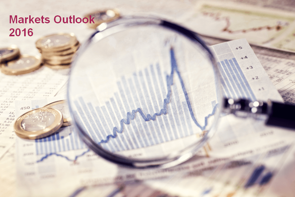 magnifying glass held over a table covered with charts and coins signifying an outlook on market conditions for 2016