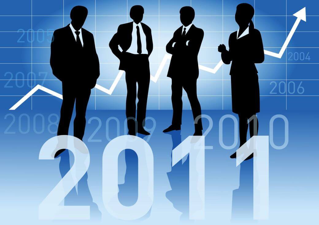 four executives in shadows, three male, one female contemplating the markets outlook through 2010 and 2011