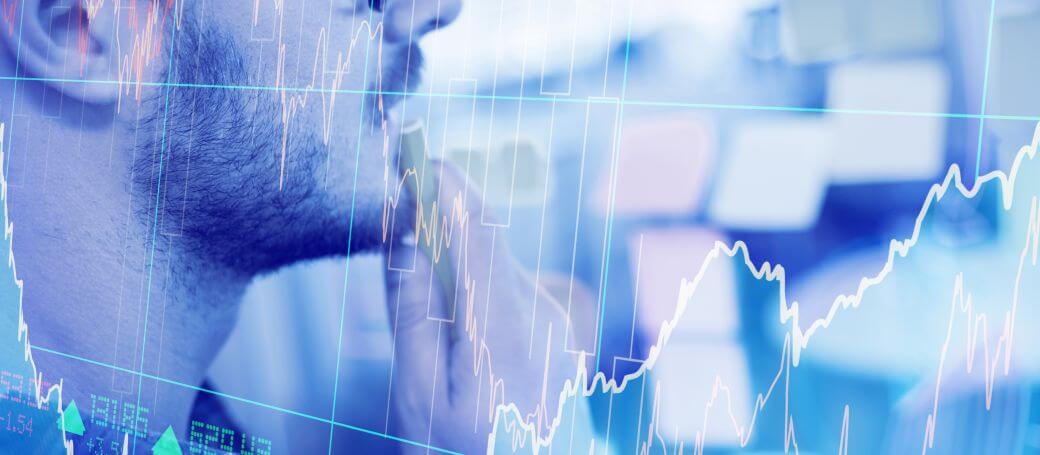 investor viewing some research notes on his wall: image overlaid by performance graphs of markets where he is reminded to beware psychological traps and adhere to investment strategies