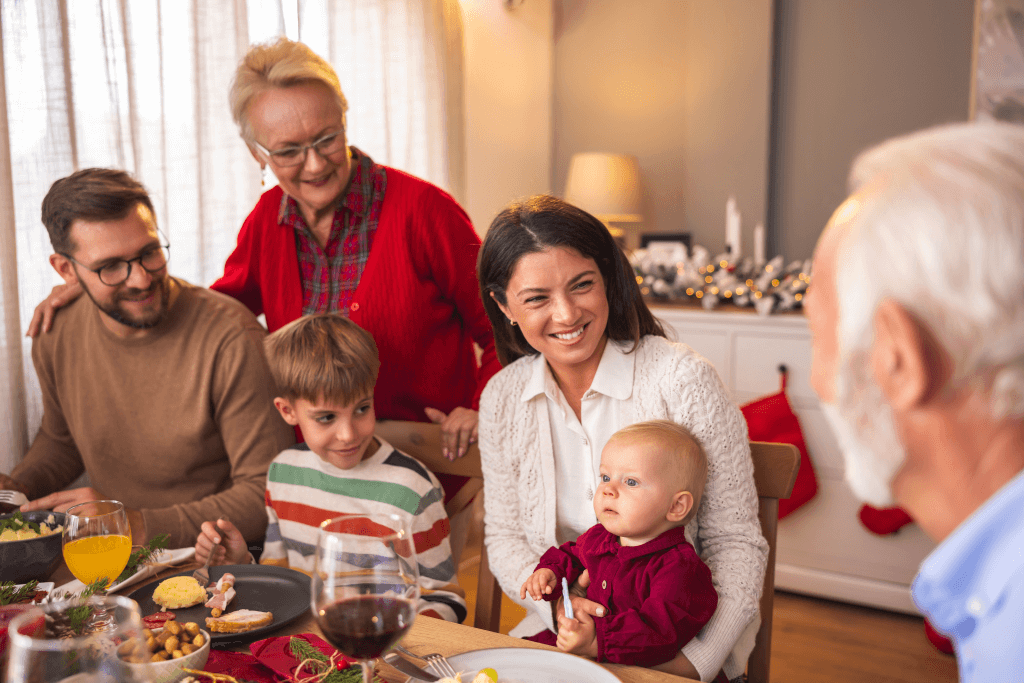 three generations of family gathered at a meal table discussing family matters and nomination of beneficiaries - a happy group of grandparents, parents and two children. estate planning outlined in this discussion - likely to include superannuation death benefits