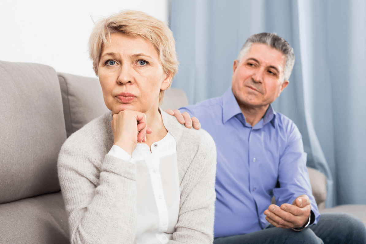 couple on a sofa unable to face each other as they deal with consequences of wealth management mistakes: could include concern in estate planning over loans to family members