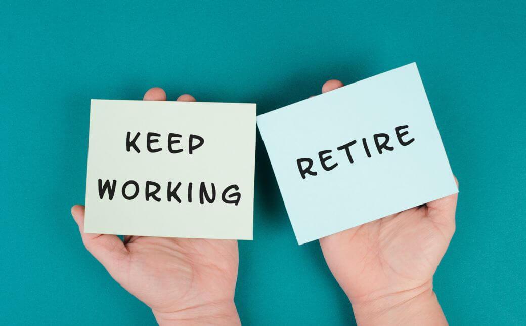 a pair of hands holding up two note pages, one with the words ;keep working', the other with the word 'retire'. Leaving viewer to contemplate planning your retirement