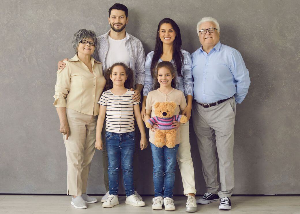 Family portrait of three generations signifying the importance of the financial support of an estate plan that incorporates a testamentary trust to benefit different generations of the family.