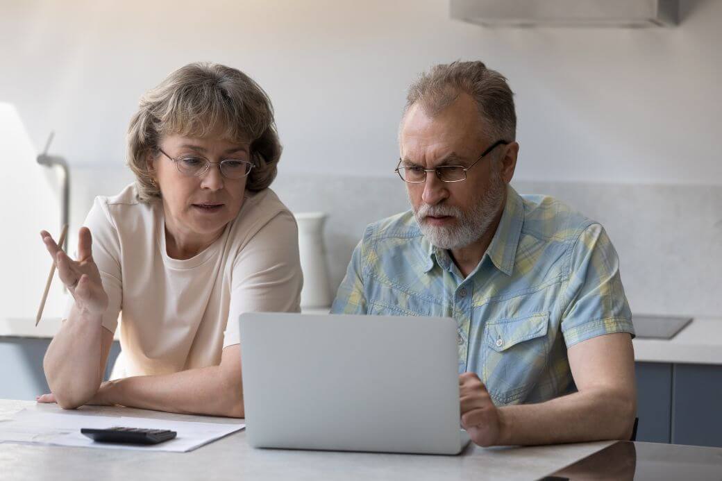 an elederly couple discussing their research into Aged Care prospects for them, and the costs that will apply with various fees being imposed; their aged care financing decisions in play