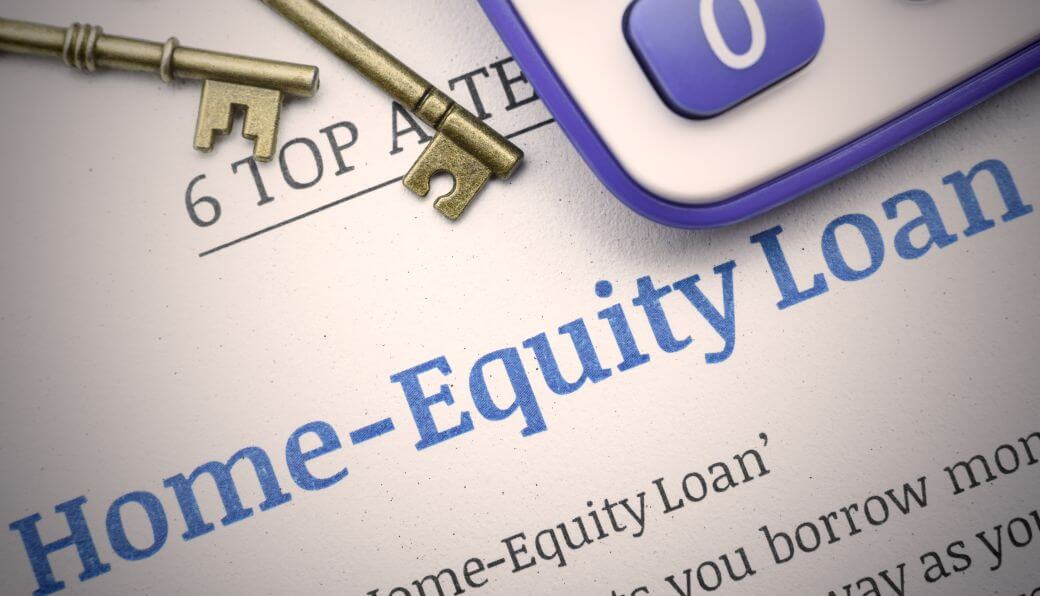 A Loan Agreement signed to enable puchase of an investment property that could be subject to negative gearing: keys to the property and a calculator also on the desk