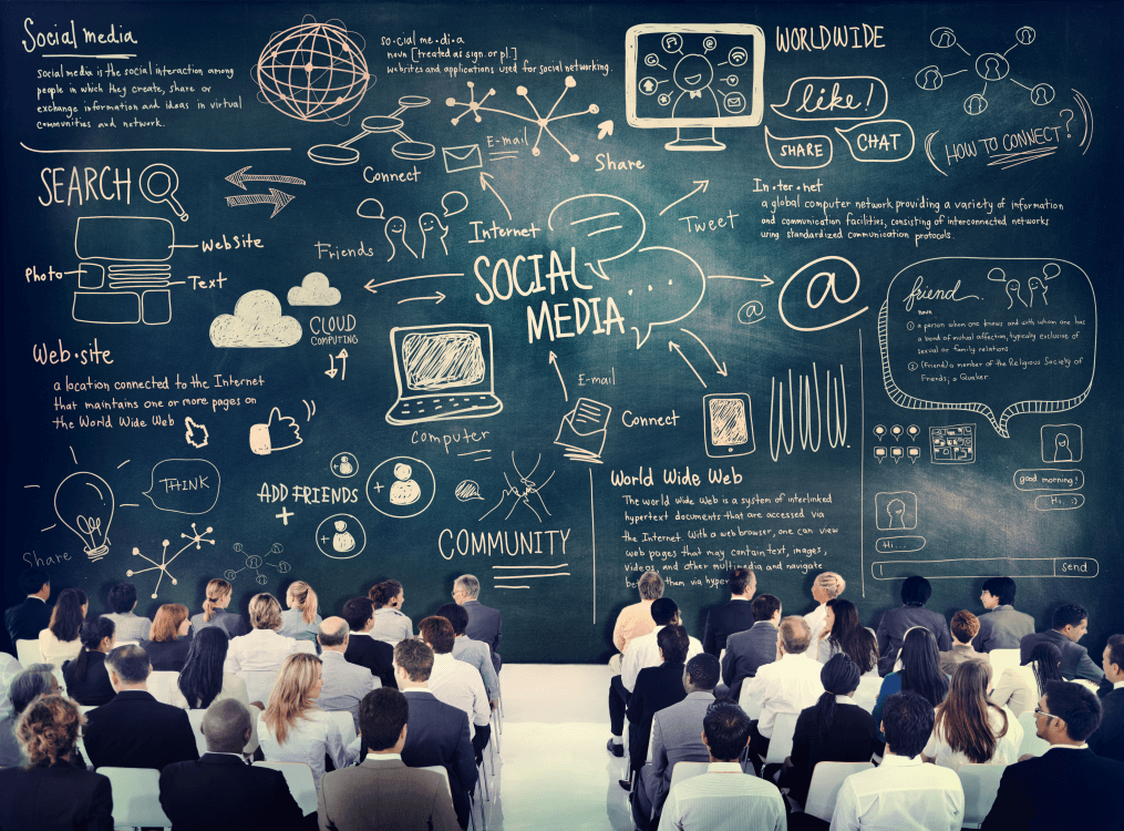 group of people seated in rows with their backs to us, facing a huge chalk board covered with social media messaging and graphic arts seeking recommendation of ContinuumFP on Google and more