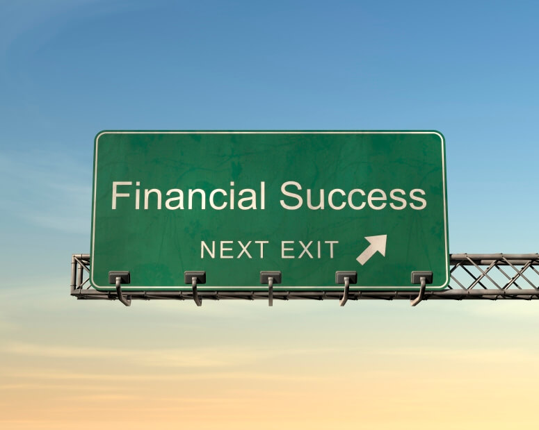 green overhead road sign with words Financial Success Next Exit with an arrow indicating direction - a metaphor for the financial success of accumulating wealth through strategic investing