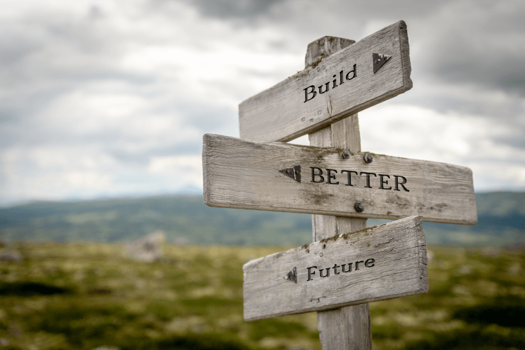 old timber signpost in a rural setting with three words on separate boards Build, Better, Future as will be assisted by Insurance Bonds revived as Investment or Education Bonds